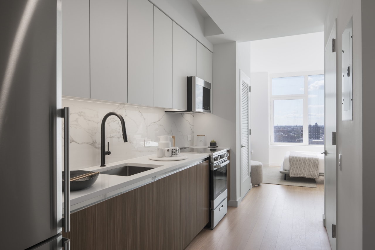 a kitchen with a sink and a mirror