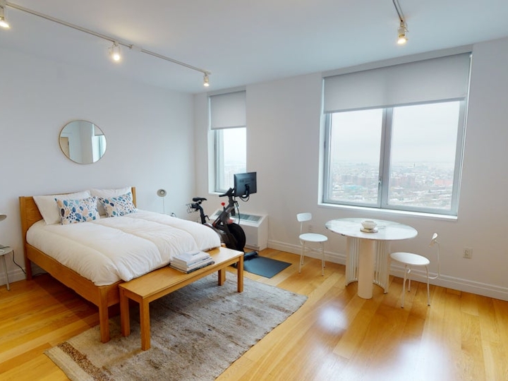 a bedroom with a wooden floor