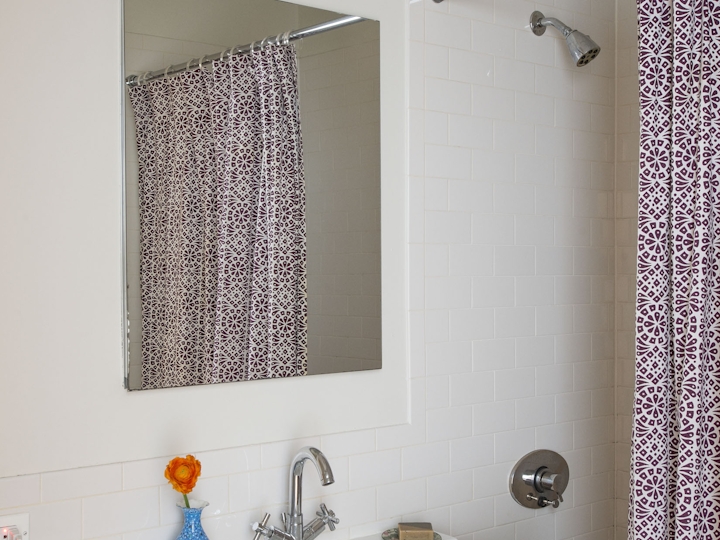 a white sink sitting under a mirror