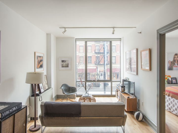 a living room filled with furniture and a large window