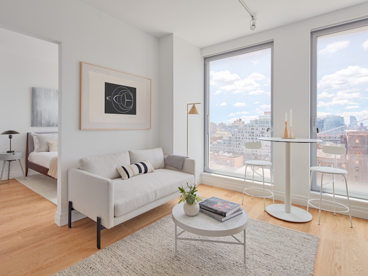 a living room filled with furniture and a large window
