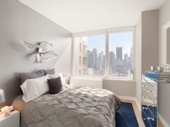 Thumbnail of Gotham West: 2717 a bedroom with a bed and desk in a room