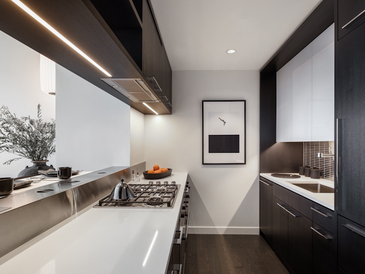 a kitchen with a sink and a mirror