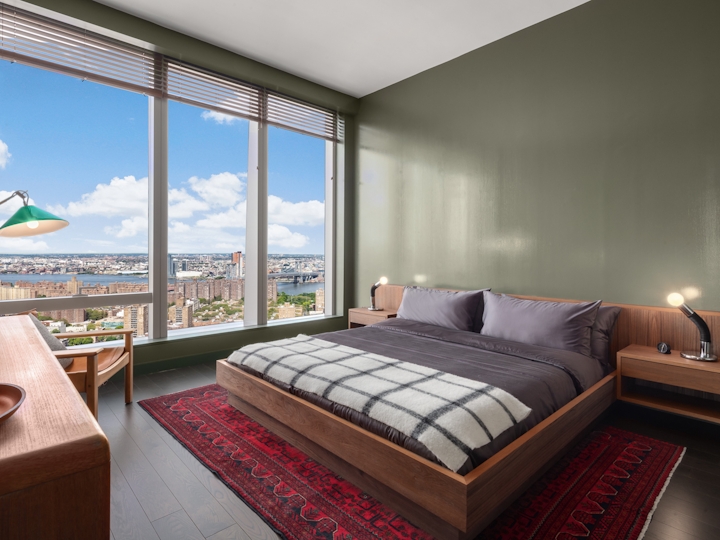 a bedroom with a bed and a large window