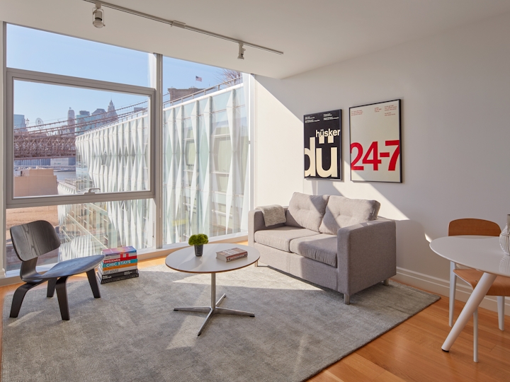 a living room filled with furniture and a large window