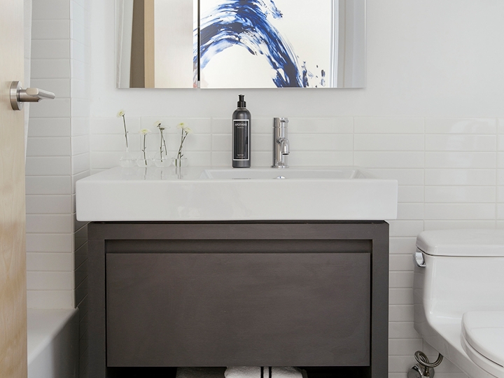 a white sink sitting under a window