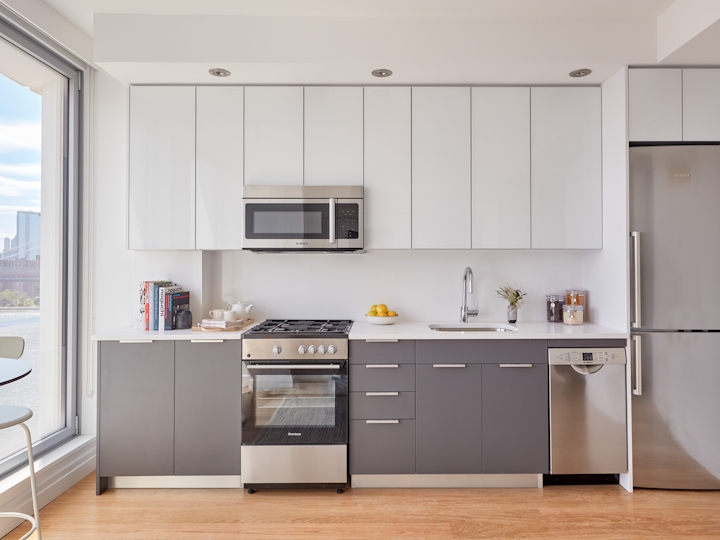 a kitchen with white cabinets and stainless steel appliances