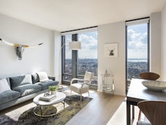 Thumbnail of The Ashland: 38G a view of a living room filled with furniture and a large window