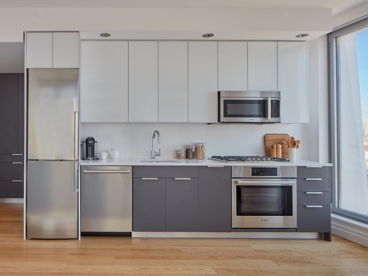 a large kitchen with stainless steel appliances and wooden cabinets