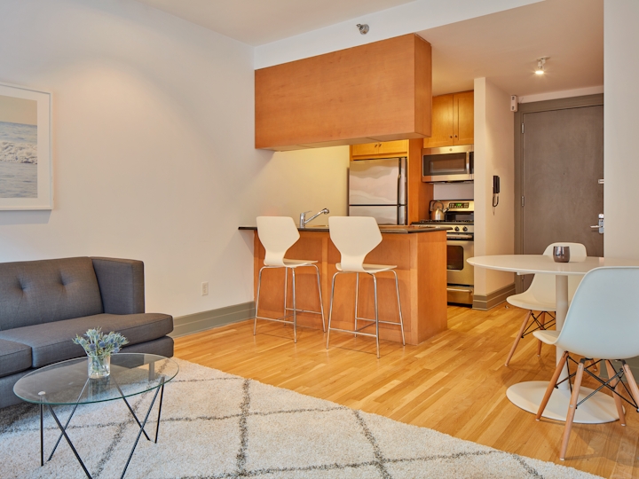 a living room filled with furniture and a wood floor