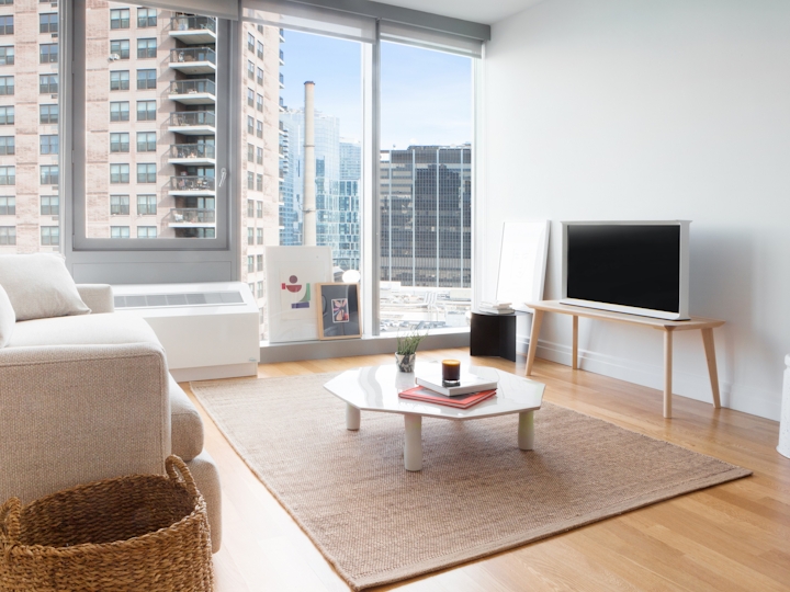 a living room filled with furniture and a large window