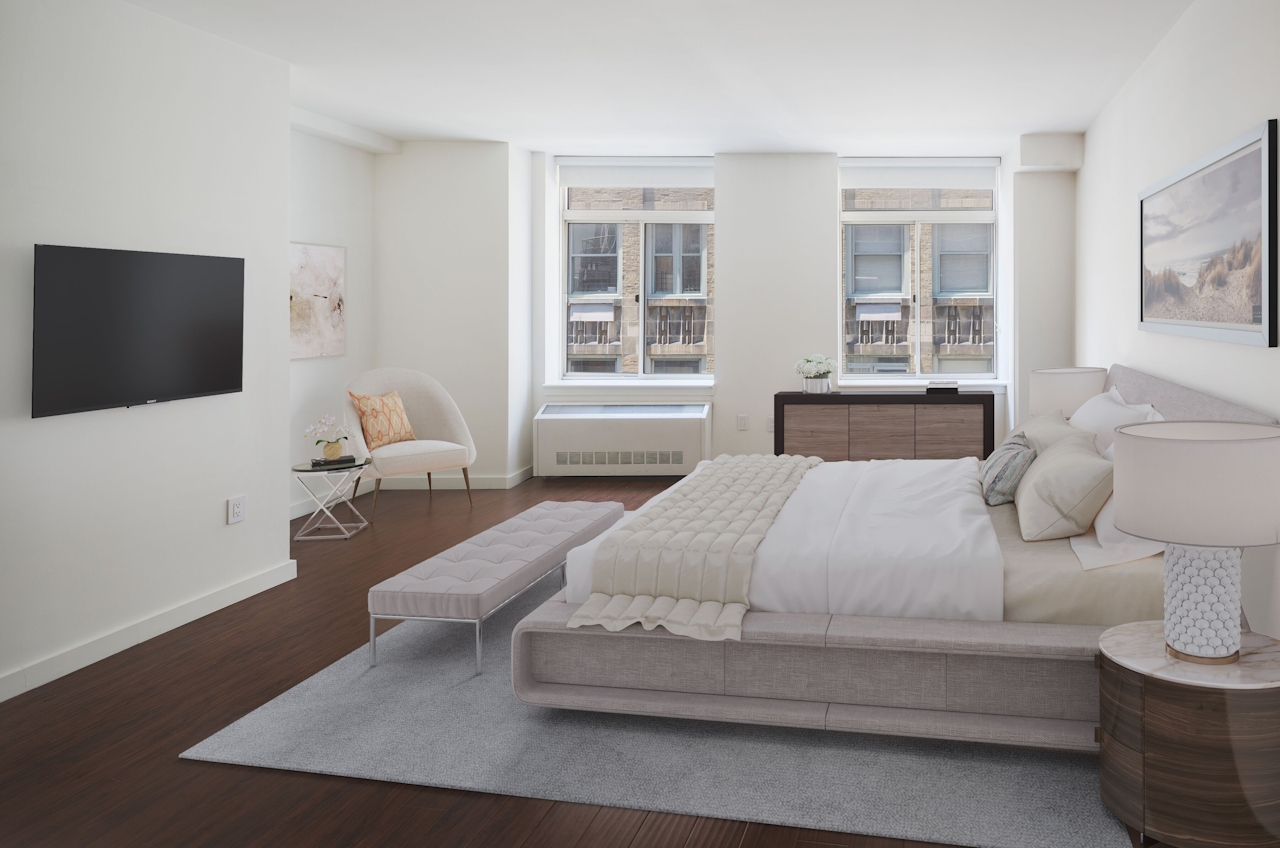 a large white bed sitting in a room