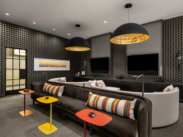 a living room filled with furniture and a lamp