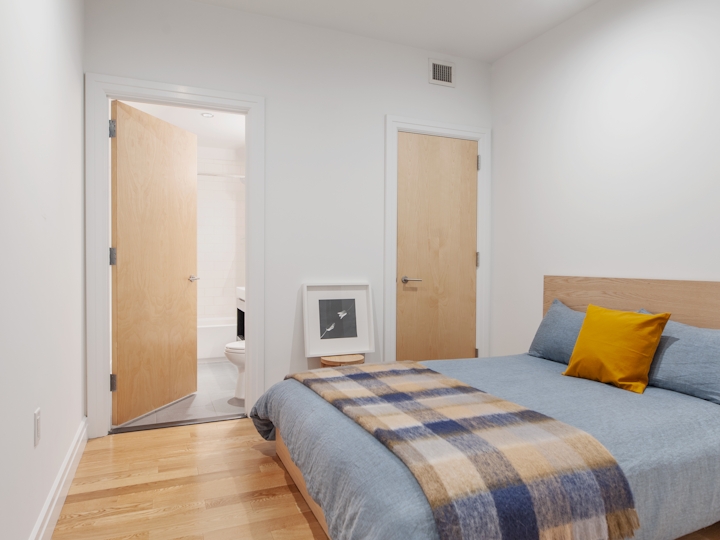 a bedroom with a bed in a room