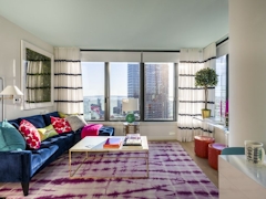 Thumbnail of The Ashland: 36D a living room filled with furniture and a large window