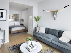 Thumbnail of The Ashland: 38G a living room filled with furniture and a table