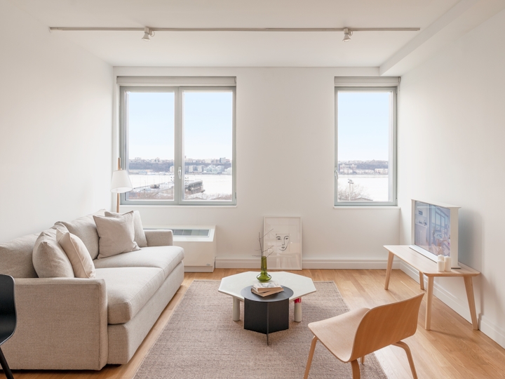 a living room filled with furniture and a large window