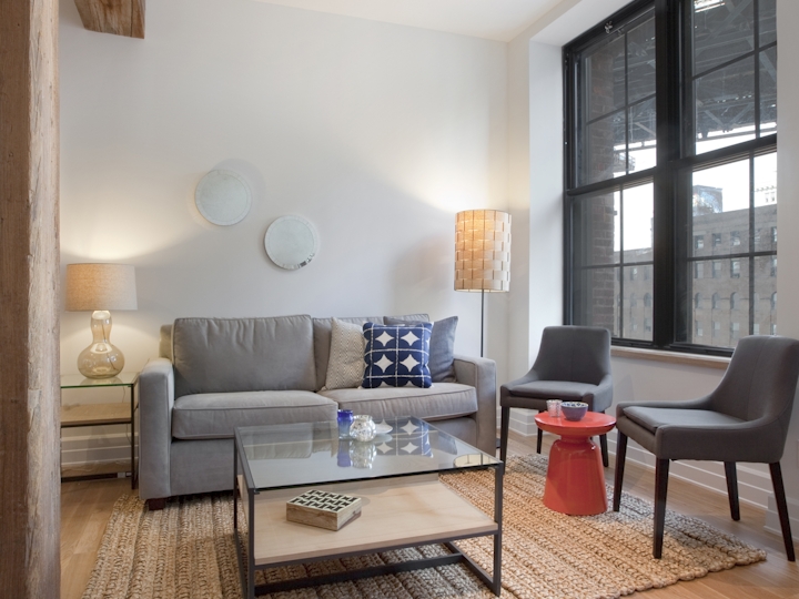 a living room filled with furniture and a large window