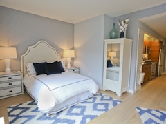 Thumbnail of Gotham West: 3009 a bedroom with a bed and desk in a room