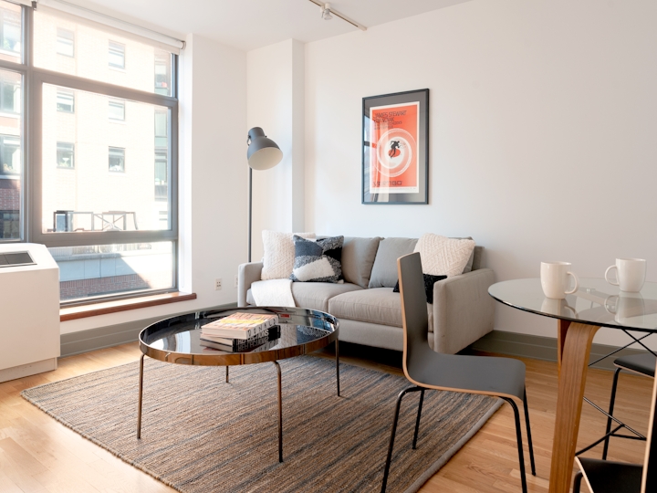a living room filled with furniture and a large window