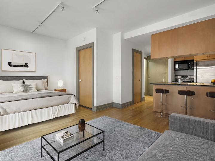 a bedroom with a bed and a mirror in a room