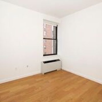 a large empty room with a wood floor