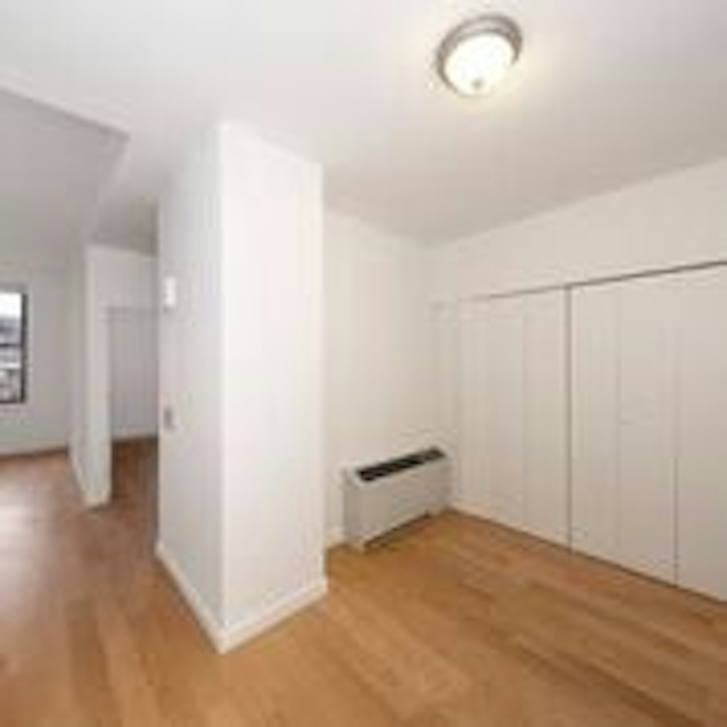 a large empty room with a wood floor