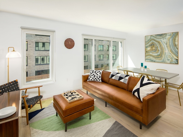 House No 94 Leasing Office Lisa Management A Living Room Filled With Furniture And Large Window