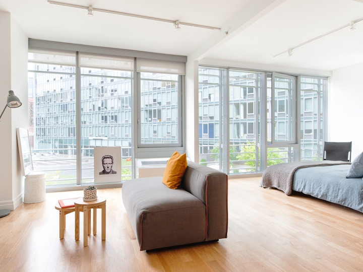 a living room filled with furniture and a large window