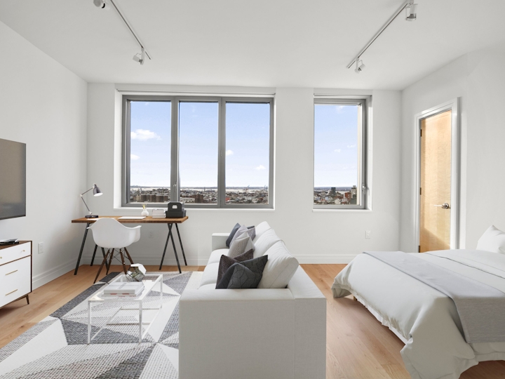 a living room filled with furniture and a large window