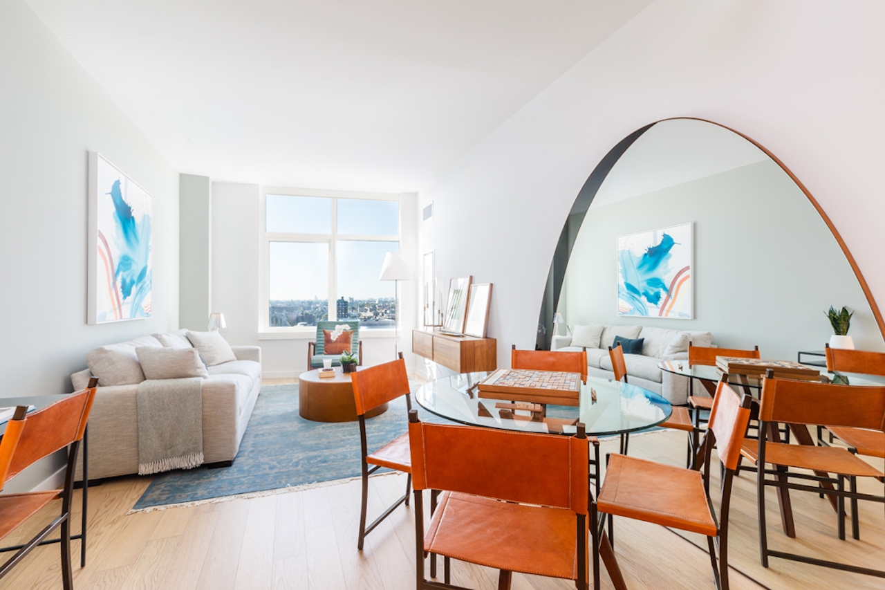 a living room filled with furniture and a large window