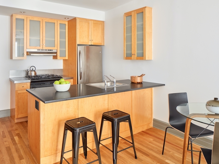 a kitchen with wooden cabinets and a dining room table