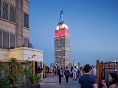 Thumbnail of Atlas New York: 39D a group of people walking in front of a tall building