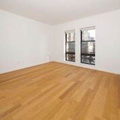 a large empty room with a hard wood floor
