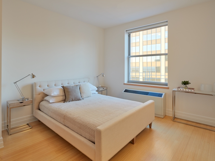 a bedroom with a bed and window in a room