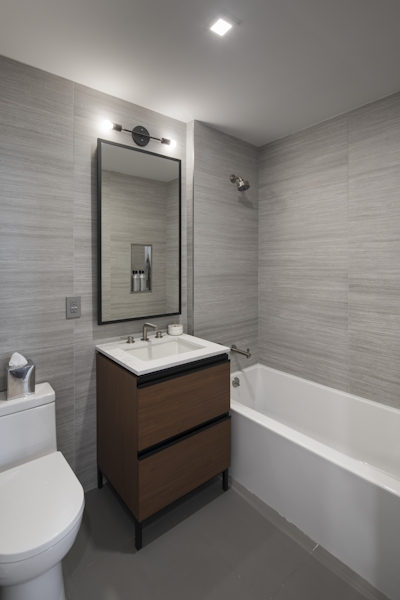 a large white tub sitting next to a sink