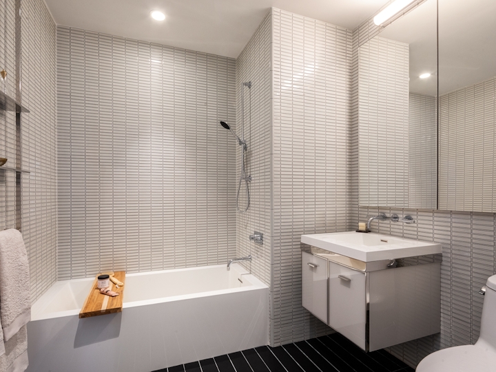 a white sink sitting next to a shower