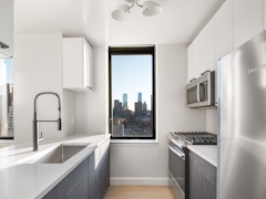 Thumbnail of The Nicole: 3E a room with a sink and a mirror