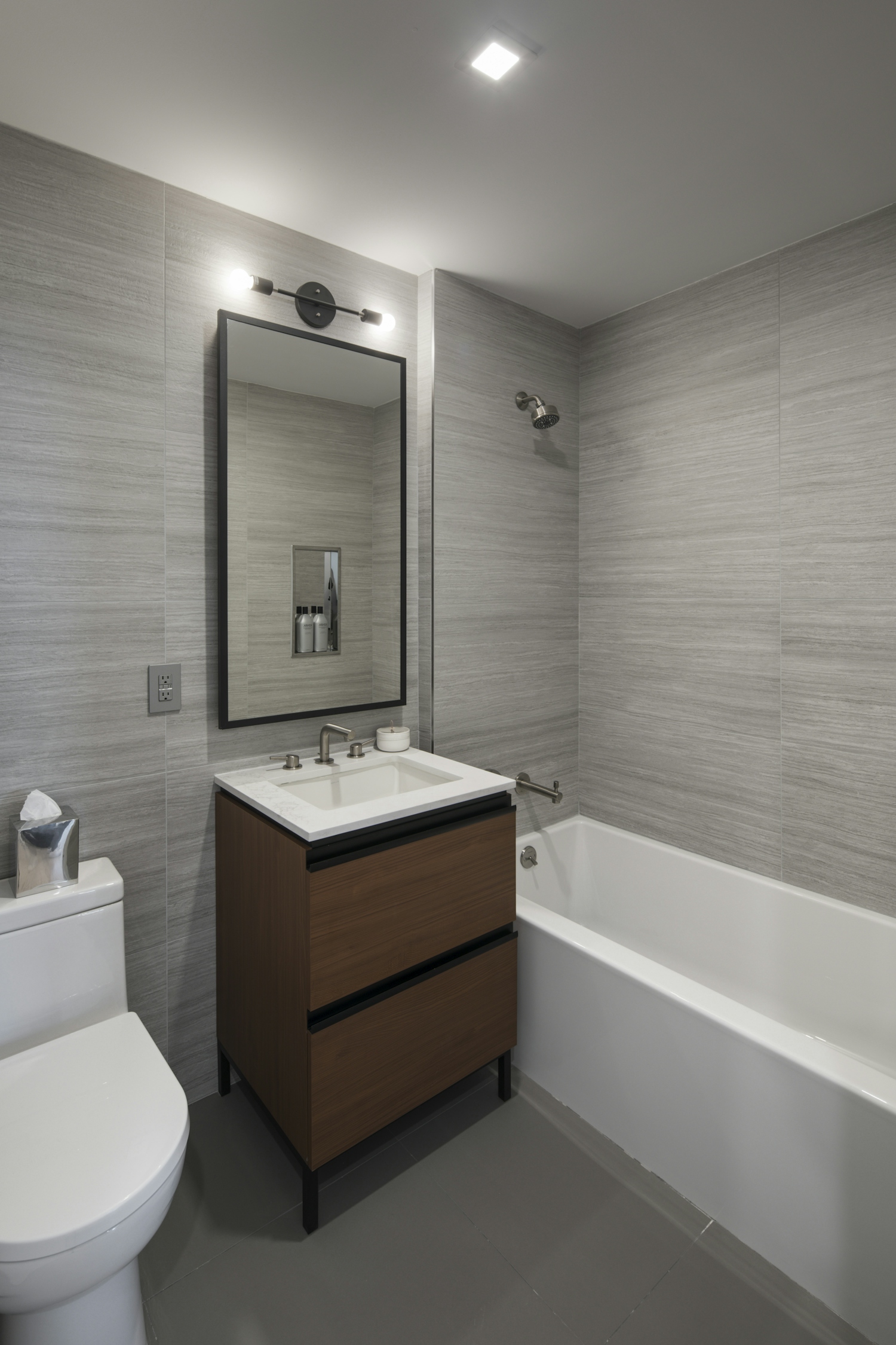 a large white tub sitting next to a sink