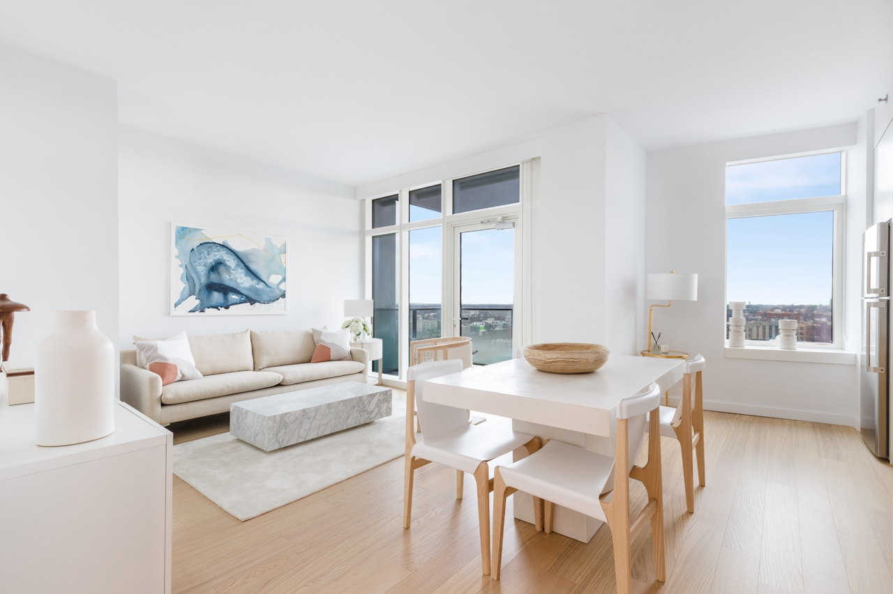 a living room filled with furniture and a large window