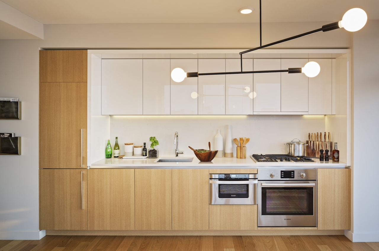 a modern kitchen with stainless steel appliances and wooden cabinets
