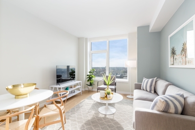 a living room filled with furniture and a large window