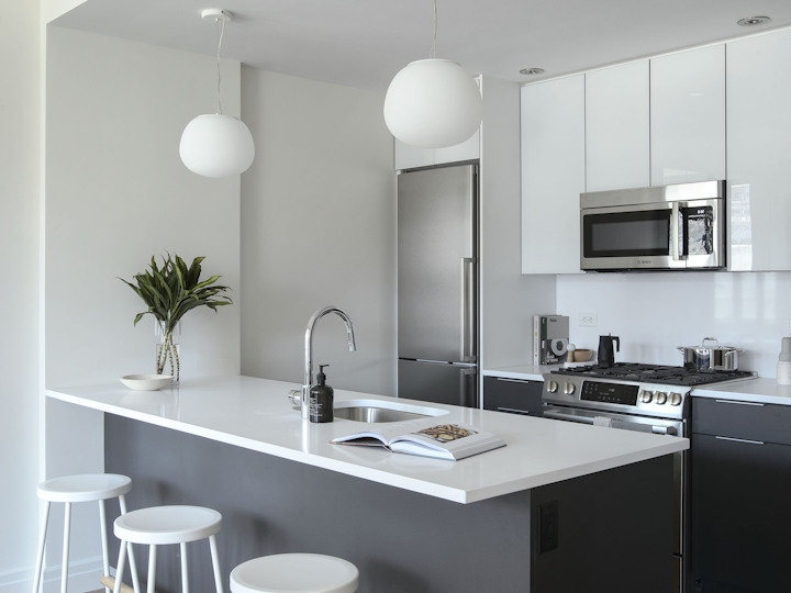 a kitchen area with a desk and chair in a room
