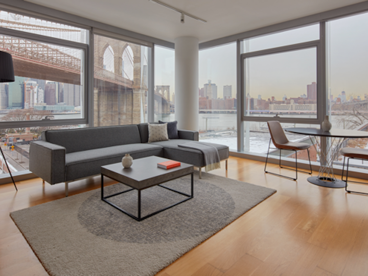 a view of a living room filled with furniture and a large window