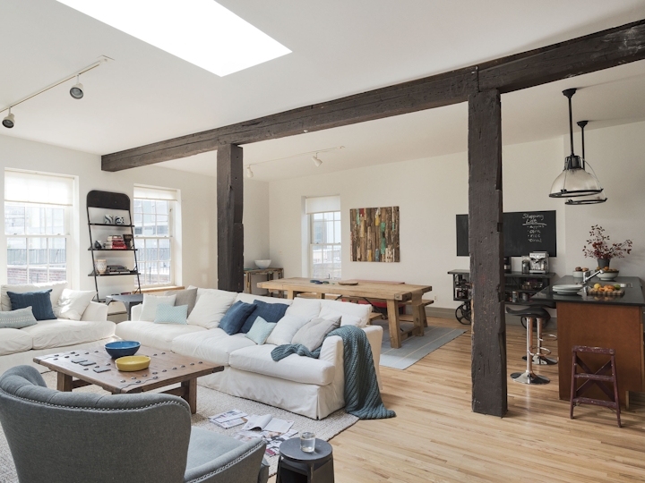 a living room filled with furniture and a large window