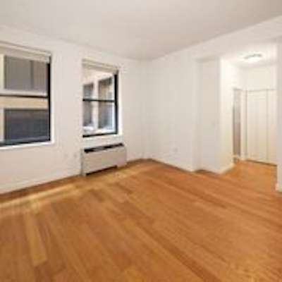 a large empty room with a hard wood floor