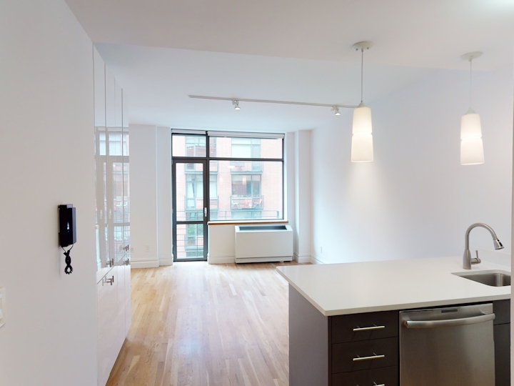 a kitchen with a sink and a mirror