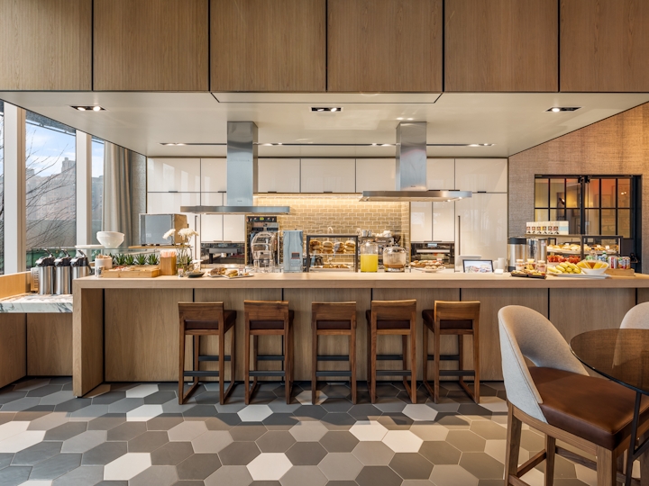 a kitchen with wooden cabinets and a dining room table