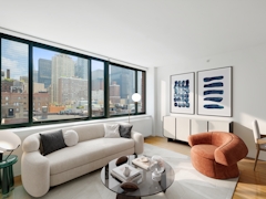 Thumbnail of The Nicole: 11D a living room filled with furniture and a large window