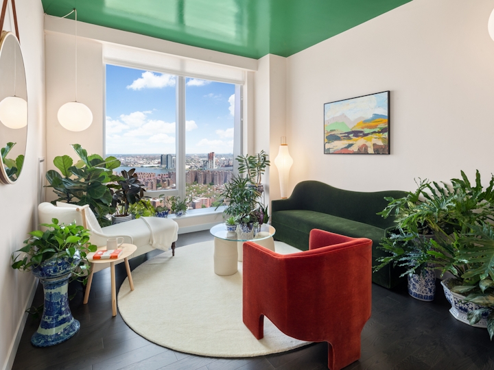 a living room filled with furniture and a large window